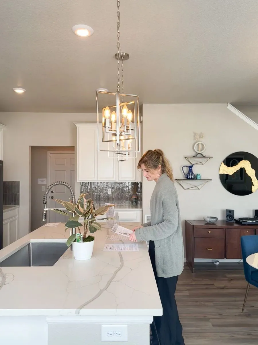 Hannah Hester reviewing paperwork at a kitchen island